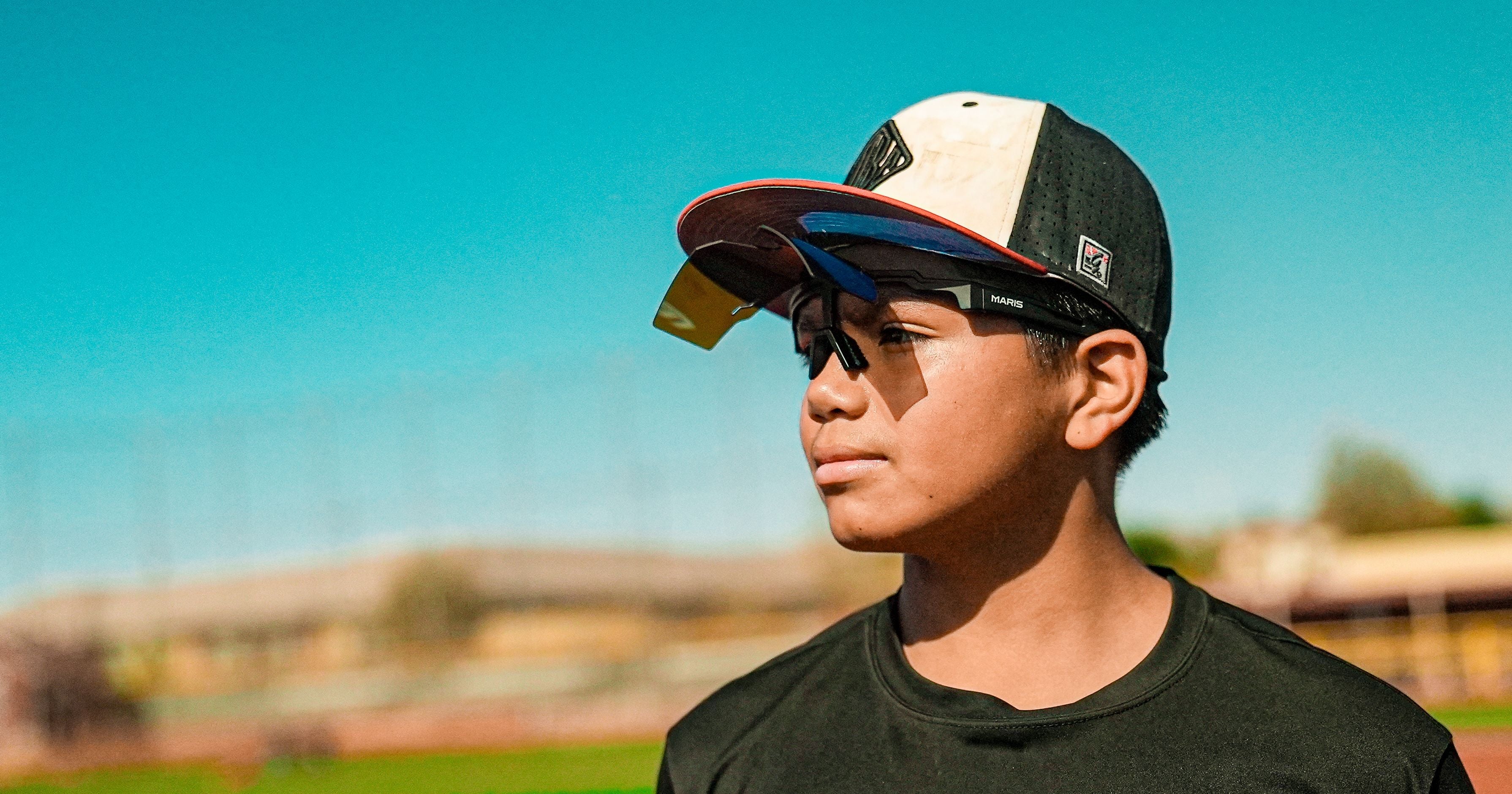 Baseball player wearing Maris Optics flip-up baseball sunglasses on the field